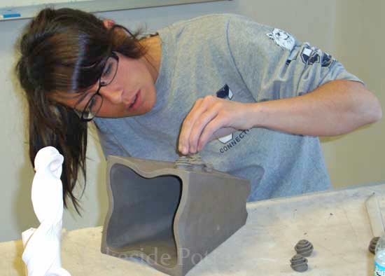 making hand built clay vase