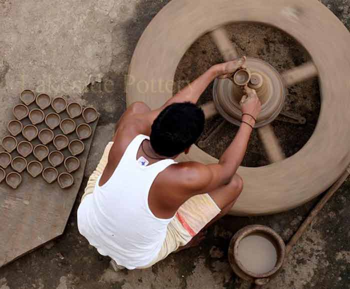 Indian potter using the same method of throwing pots as thousands of years ago