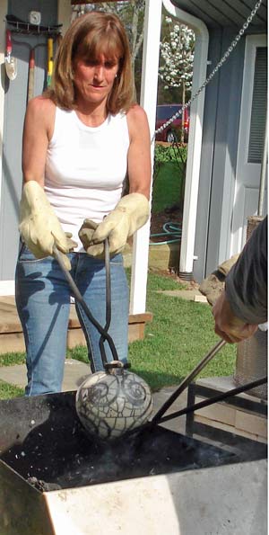 remving pots from raku reduction chamber