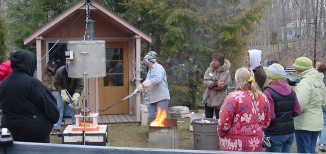 Remving pots from raku kiln using tangs