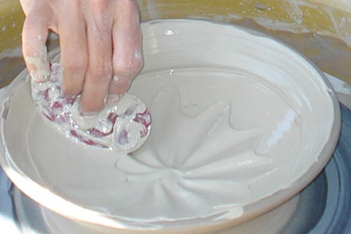 Using slip on the pottery wheel for pattern