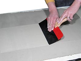 Smooting clay slab before cutting a tile