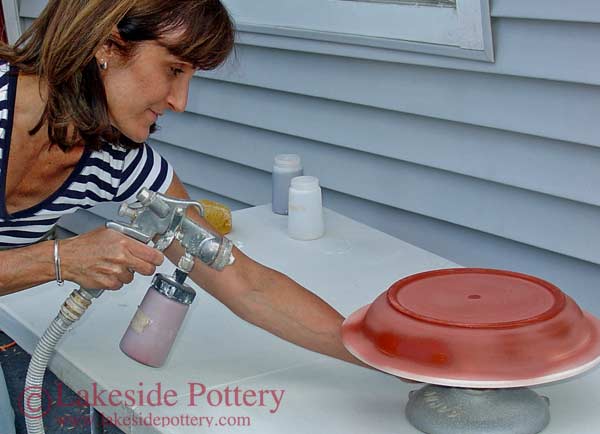 Airbrush spraying glaze on pottery - Patty Storms