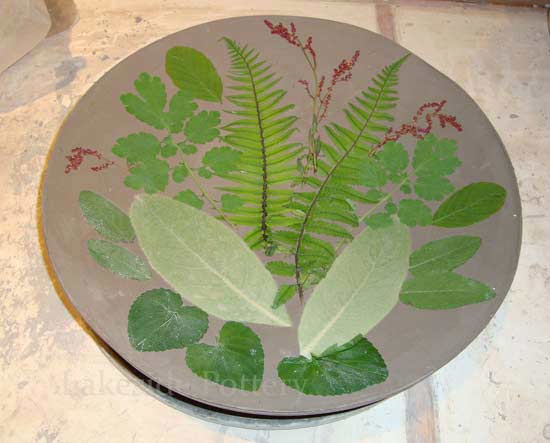 impressing leaves into clay for texture