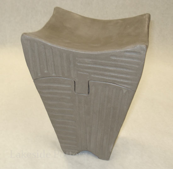 tall carved clay box with puzzle lid