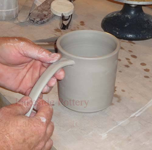 Throwing a mug on the pottery wheel