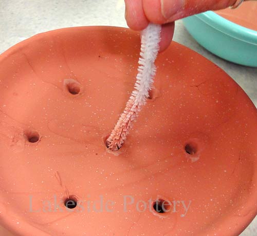 Use wet pipe cleaner to clear holes from glaze to prevent clogging