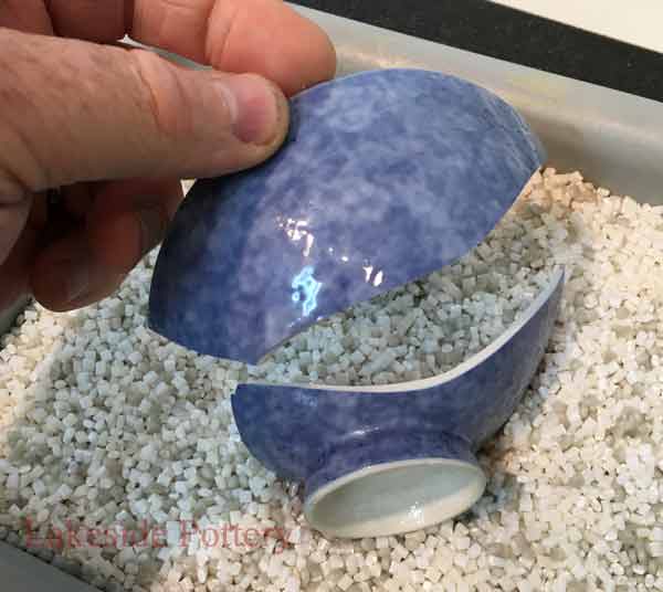 Placing two broken pottery pieces together