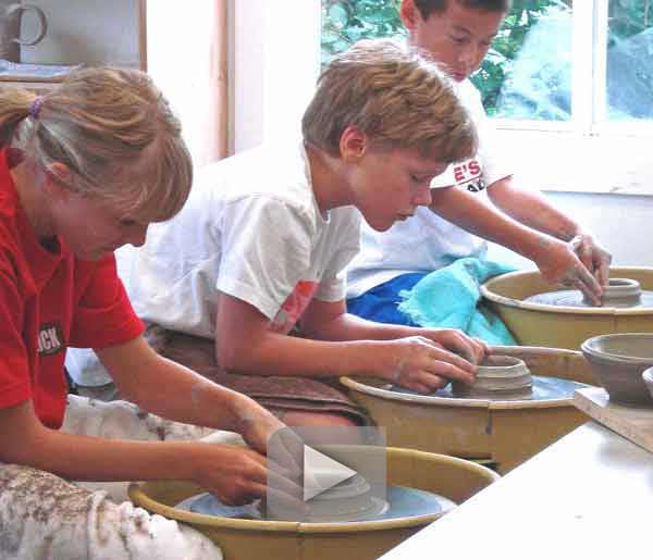 three children on the pottery wheel