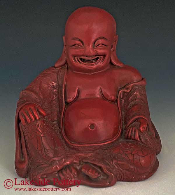 Vintage laughing buddha statue repaired