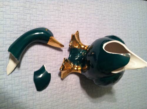 broken green ceramic goose