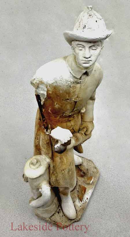 Broken fireman plaster statue