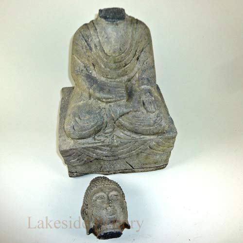 Buddha garden stone statue with broken head and missing ear