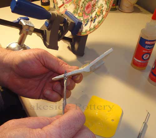 applying glue to broken ceramic 